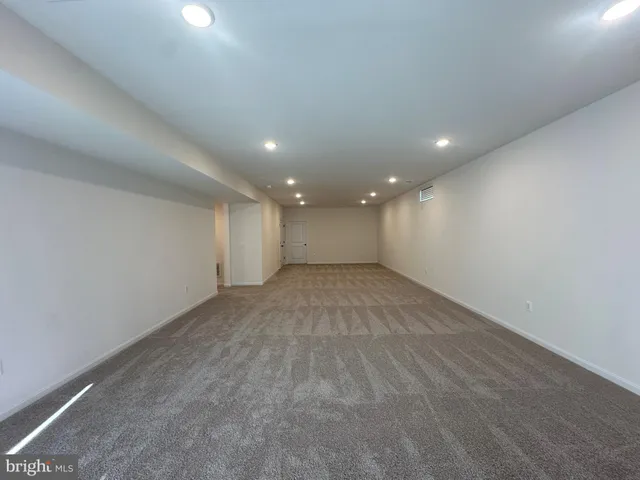 a bathroom with a granite countertop sink toilet a shower and a mirror