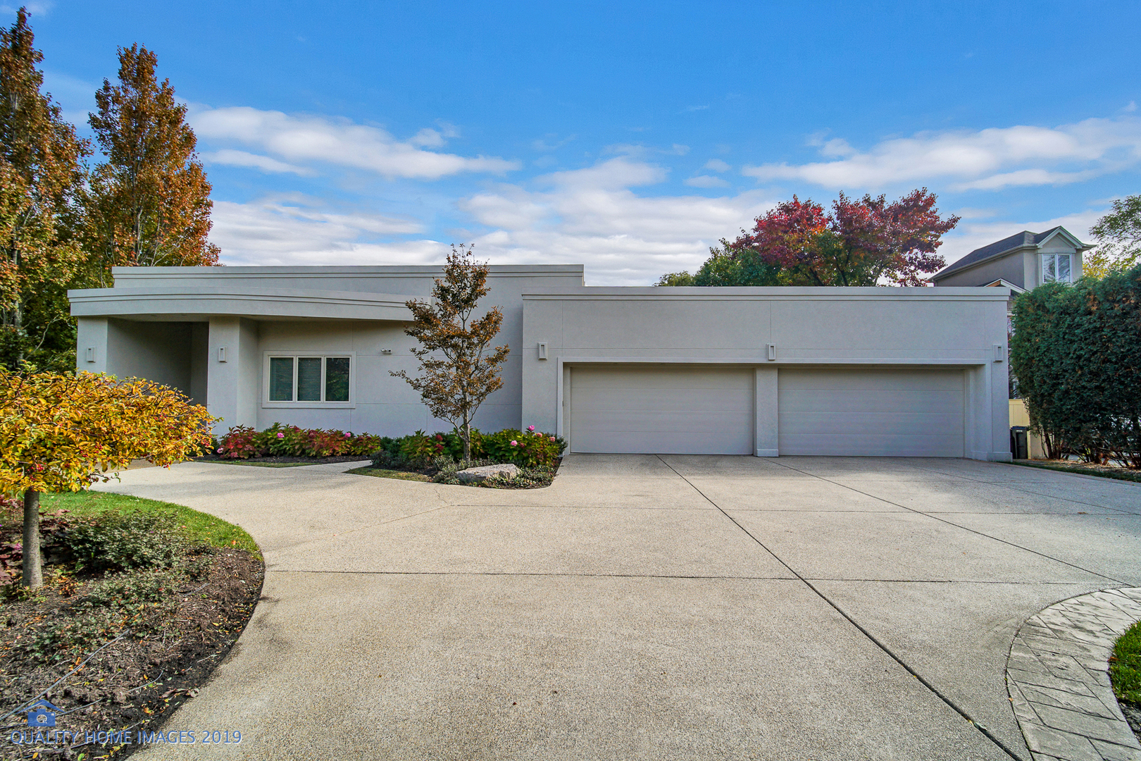 a front view of a house with a yard and a garage