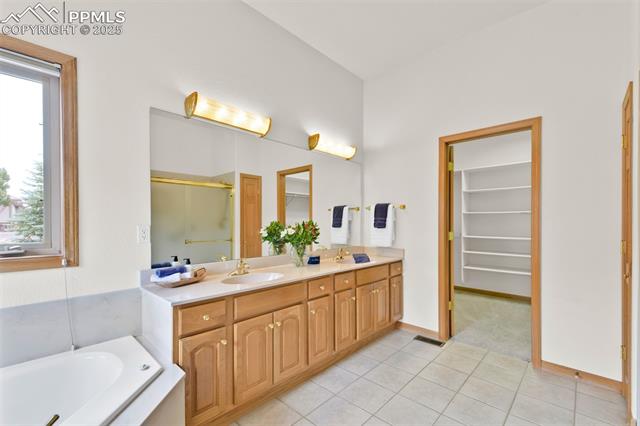 6240 Wilson Road Colorado Springs, CO 80919 - Photo 22 of 42 5 piece primary bathroom with spa soaker tub, and large walk-in closet