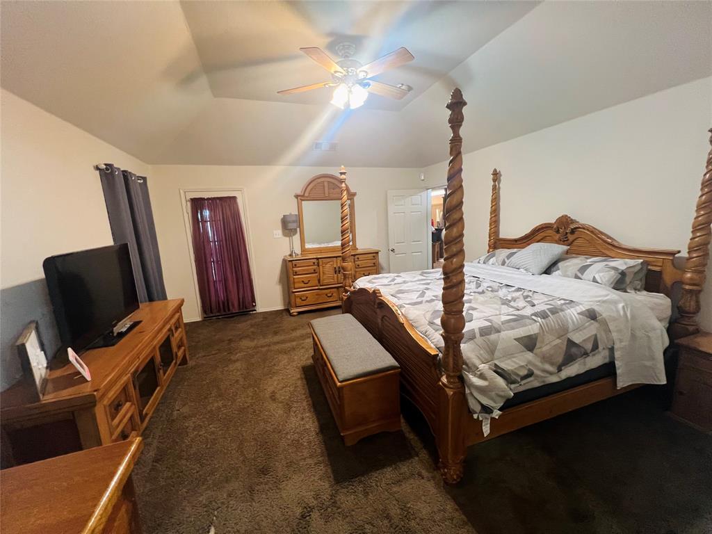 469 Streetman Road Royse City, TX 75189 - Photo 11 of 36 Bedroom with dark carpet, a ceiling fan, and vaulted ceiling