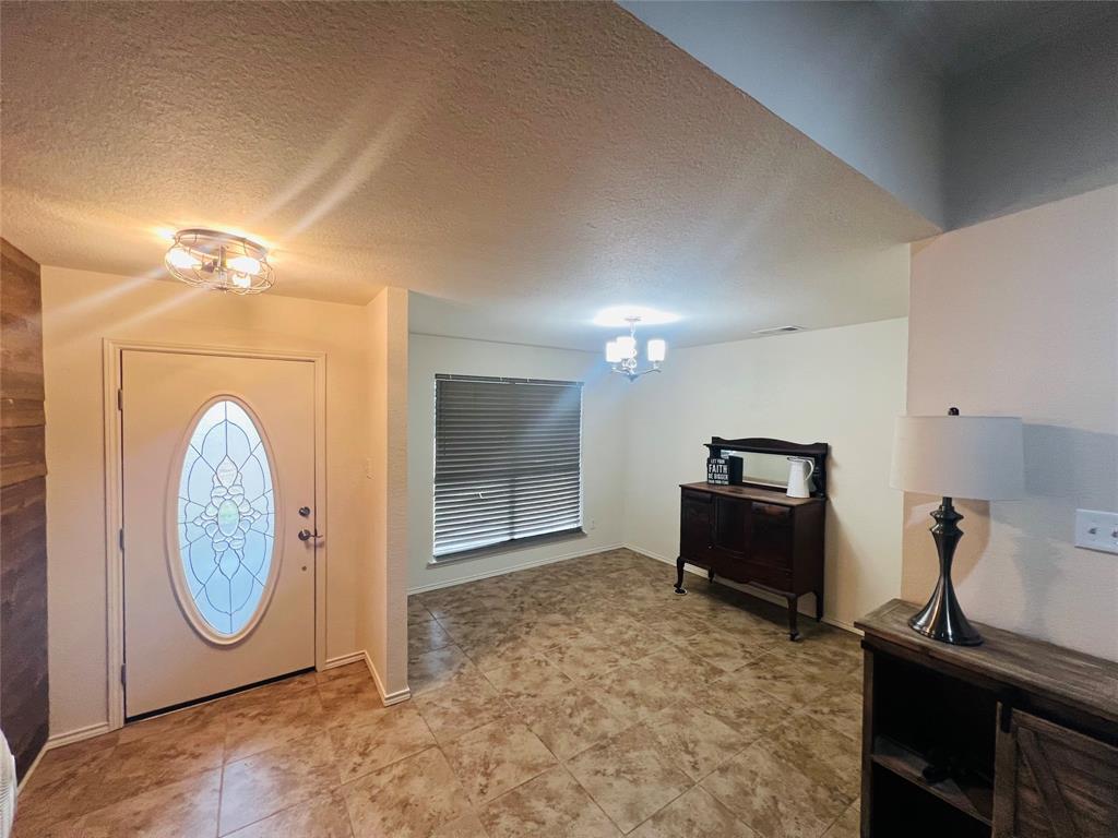 469 Streetman Road Royse City, TX 75189 - Photo 5 of 36 Foyer with a chandelier and a textured ceiling