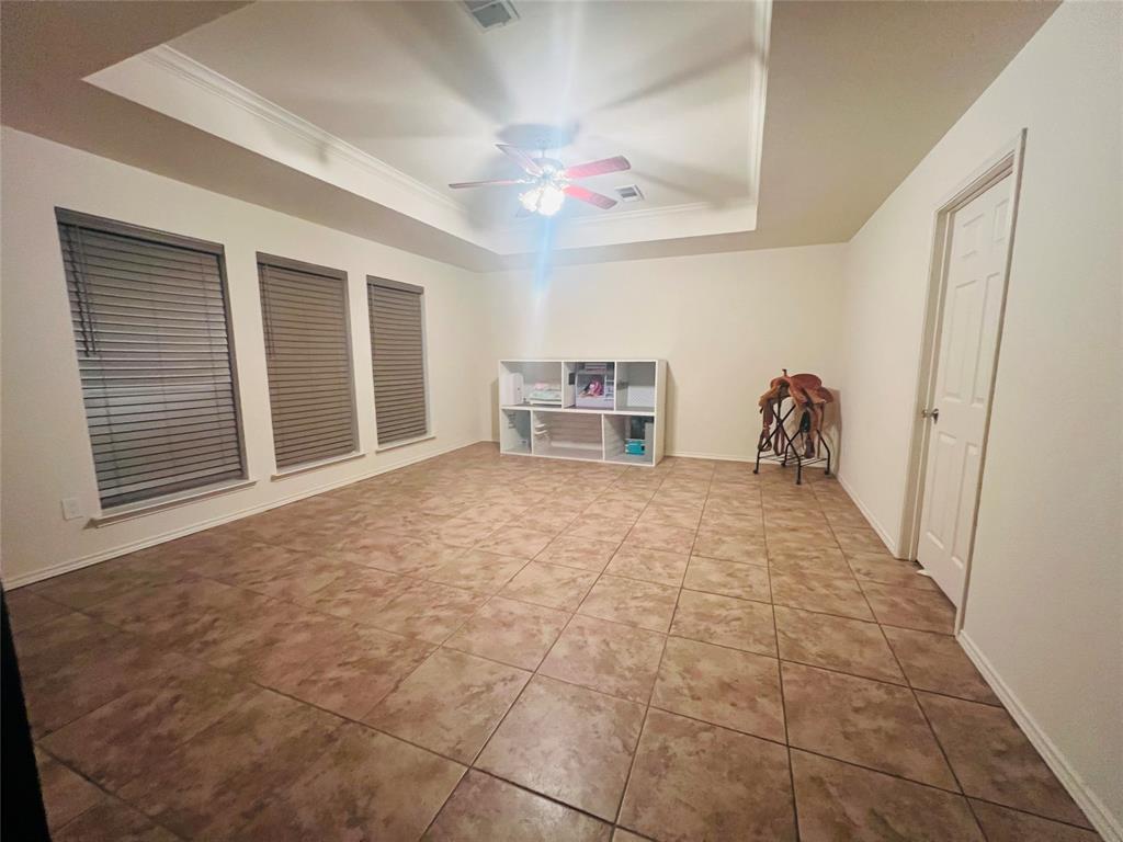 469 Streetman Road Royse City, TX 75189 - Photo 6 of 36 Game room featuring a raised ceiling, a ceiling fan, tile patterned floors, and crown molding