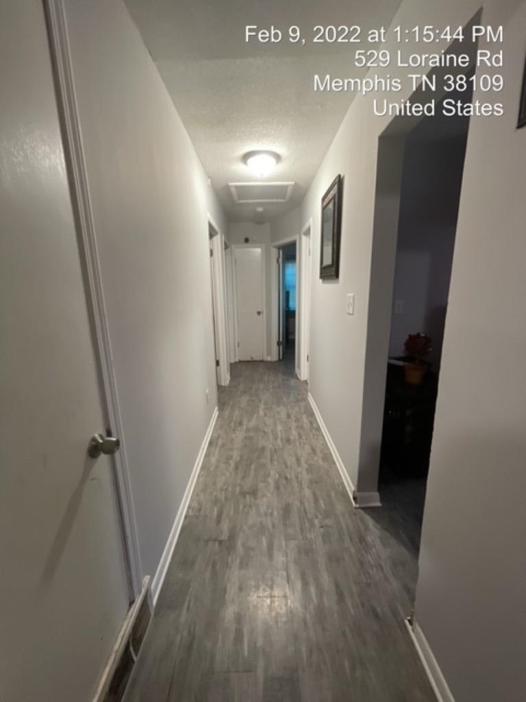 529 Loraine Road Memphis, TN 38109 - Photo 11 of 20 a view of a hallway with wooden floor and staircase