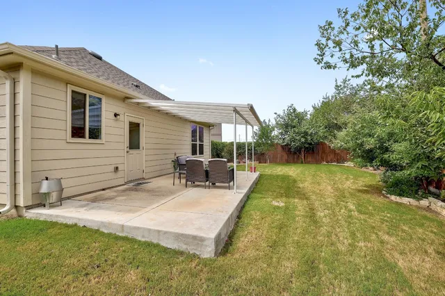 a view of a house with backyard porch and sitting area