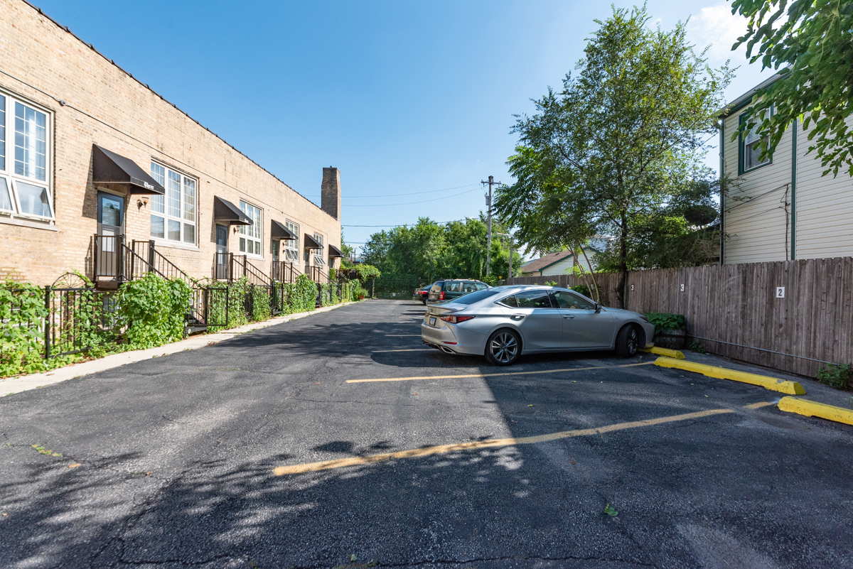 2415 West 24th Street, Unit 6 Chicago, IL 60608 - Photo 12 of 12 a couple of cars parked in front of a house