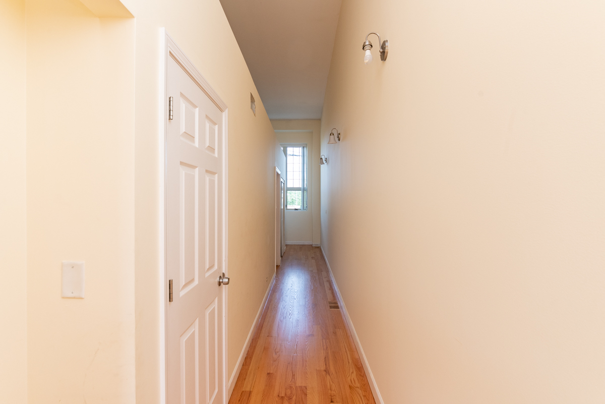 2415 West 24th Street, Unit 6 Chicago, IL 60608 - Photo 7 of 12 a view of a hallway with wooden floor