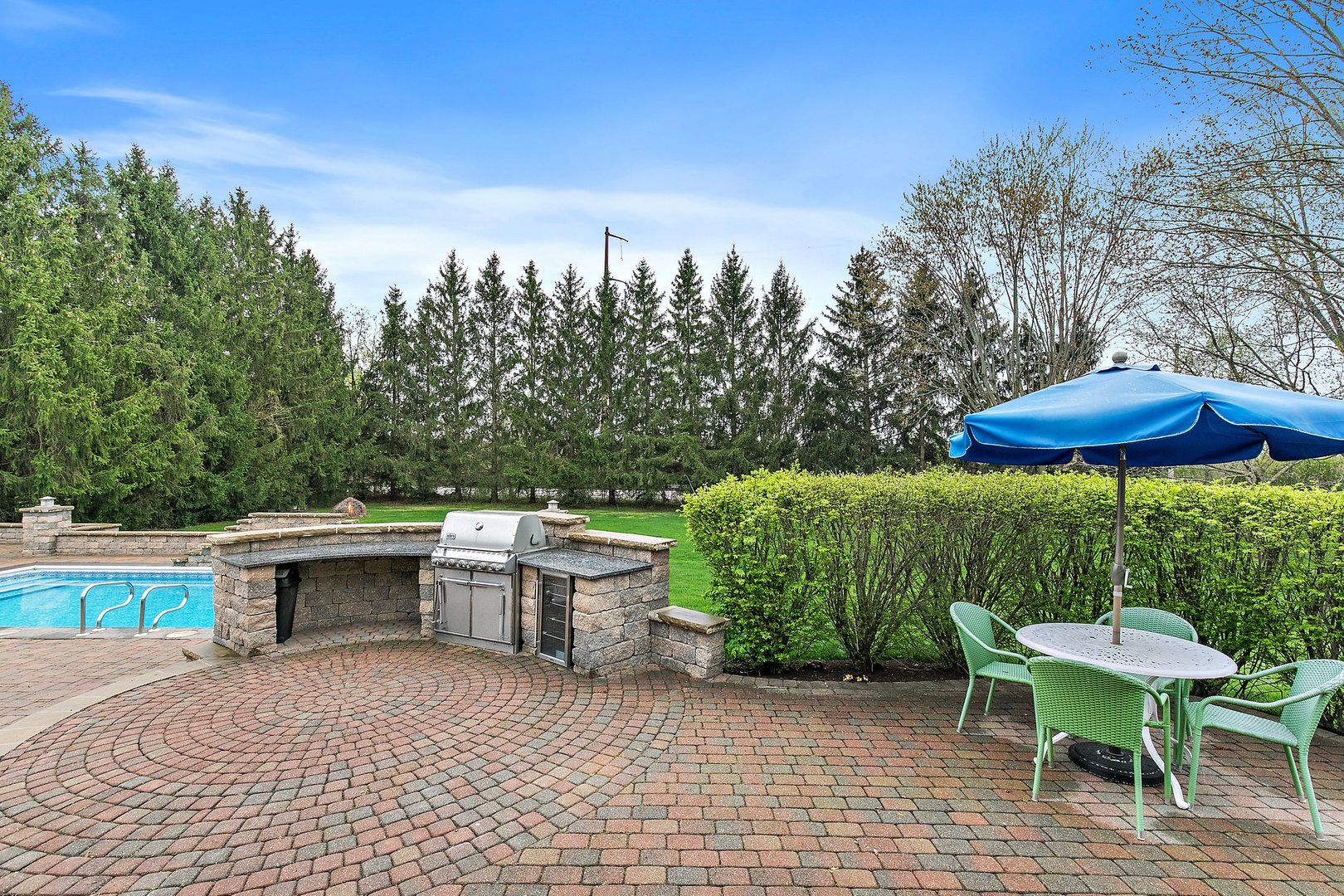 39W343 Hogan Hill Elgin, IL 60124 - Photo 13 of 48 a view of a patio with table and chairs under an umbrella