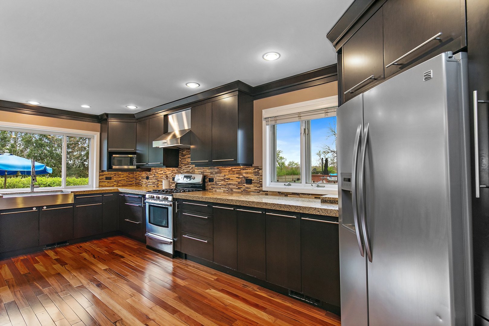 39W343 Hogan Hill Elgin, IL 60124 - Photo 15 of 48 a kitchen with stainless steel appliances granite countertop a refrigerator a sink dishwasher a stove and white countertops with wooden floor