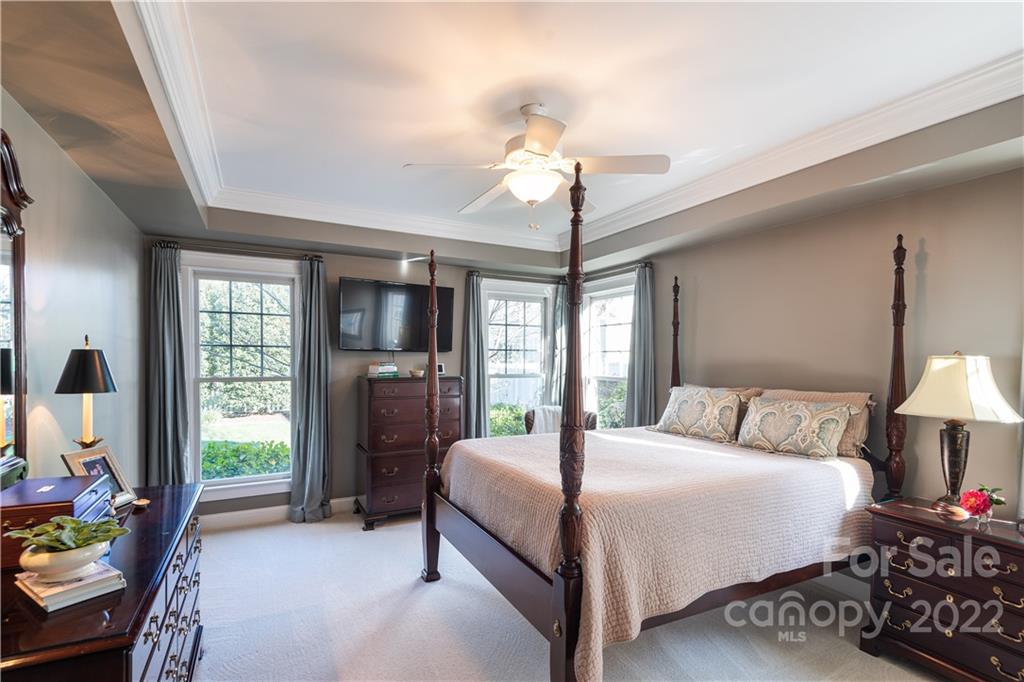 908 Gardenia Street Fort Mill, SC 29708 - Photo 16 of 39 a bedroom with a bed and a chandelier