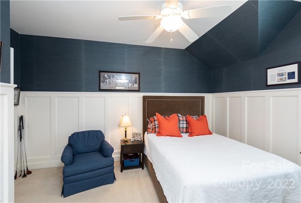 908 Gardenia Street Fort Mill, SC 29708 - Photo 21 of 39 a bedroom with bed and a chandelier