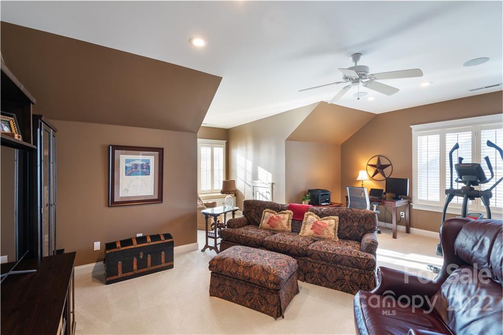 908 Gardenia Street Fort Mill, SC 29708 - Photo 26 of 39 a living room with furniture a lamp and a flat screen tv