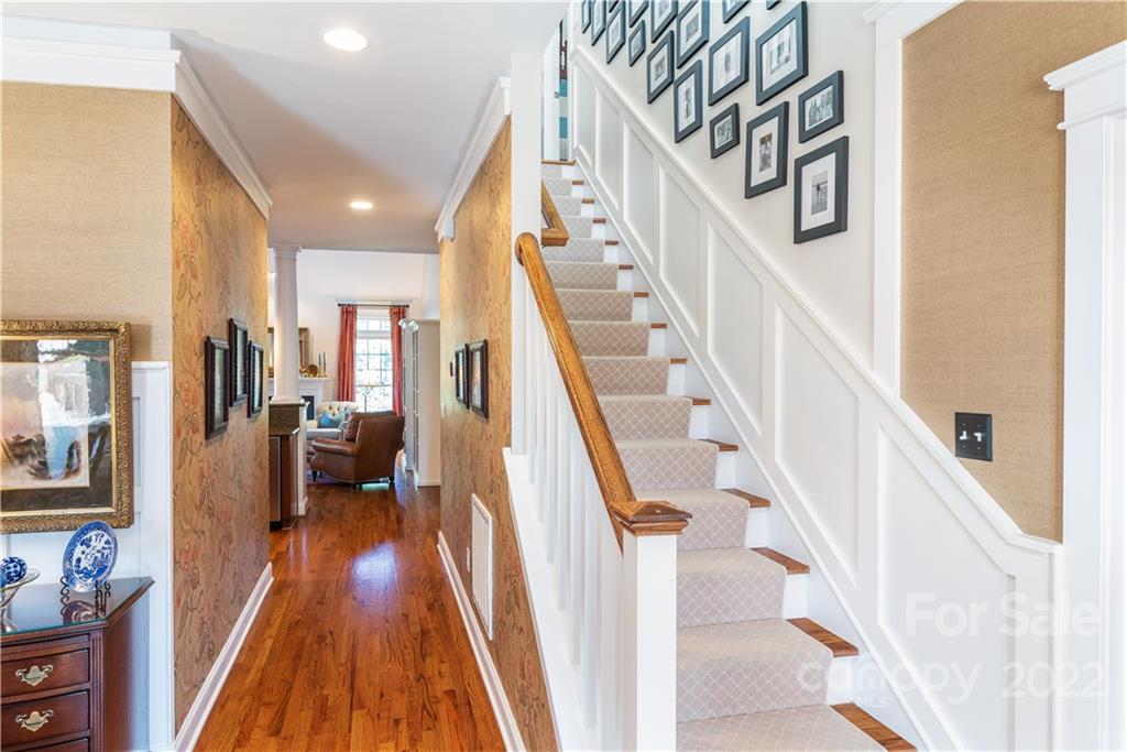 908 Gardenia Street Fort Mill, SC 29708 - Photo 7 of 39 a view of staircase with lots of frames on wall and a dining table