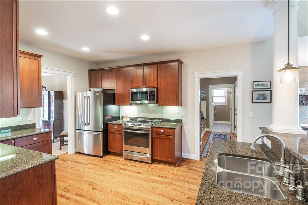 908 Gardenia Street Fort Mill, SC 29708 - Photo 8 of 39 a kitchen with stainless steel appliances granite countertop a stove refrigerator and sink