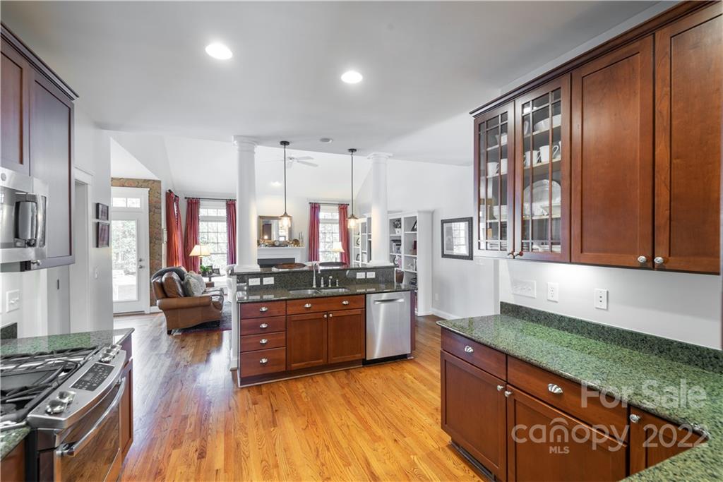 908 Gardenia Street Fort Mill, SC 29708 - Photo 9 of 39 a large kitchen with stainless steel appliances granite countertop a stove a sink dishwasher and a large refrigerator