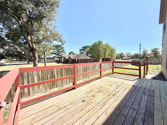a view of balcony with wooden floor and fence