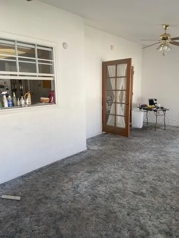 an empty room with windows and closet
