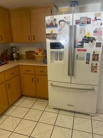 a kitchen with stainless steel appliances a refrigerator sink and cabinets