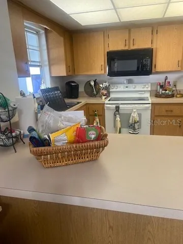 a kitchen with stainless steel appliances granite countertop a sink a stove and a microwave