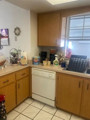 a kitchen with a sink cabinets and window