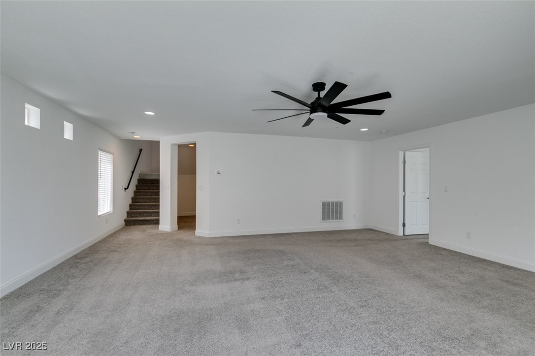 6335 Rock Strm Lane Las Vegas, NV 89141 - Photo 11 of 61 Unfurnished living room featuring light carpet, stairs, recessed lighting, and a ceiling fan