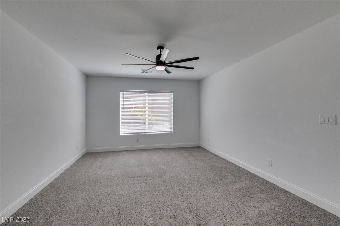 6335 Rock Strm Lane Las Vegas, NV 89141 - Photo 14 of 61 Unfurnished room with light colored carpet and a ceiling fan