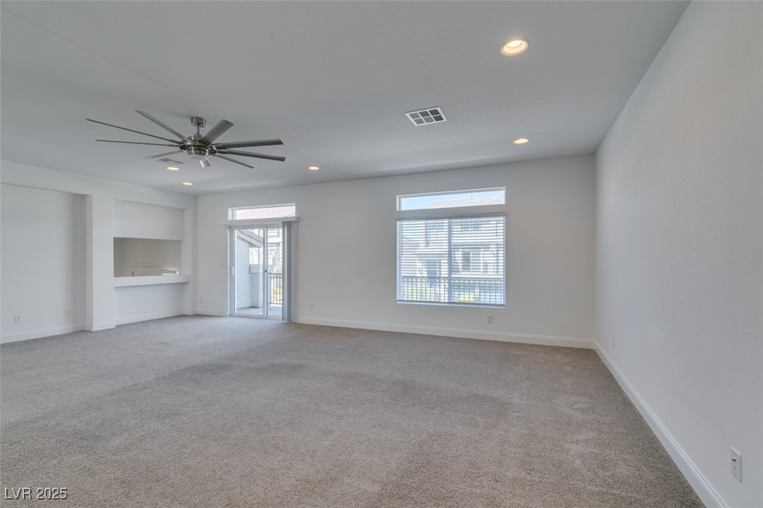 6335 Rock Strm Lane Las Vegas, NV 89141 - Photo 23 of 61 Unfurnished living room with light colored carpet, recessed lighting, and ceiling fan
