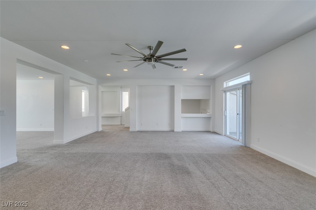 6335 Rock Strm Lane Las Vegas, NV 89141 - Photo 25 of 61 Unfurnished living room featuring light carpet, recessed lighting, and a ceiling fan