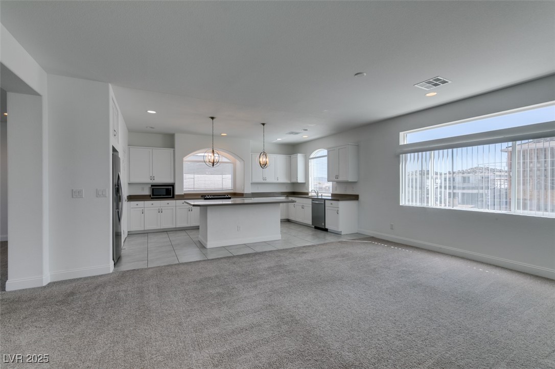 6335 Rock Strm Lane Las Vegas, NV 89141 - Photo 61 of 61 Kitchen with light carpet, open floor plan, decorative light fixtures, a chandelier, and recessed lighting