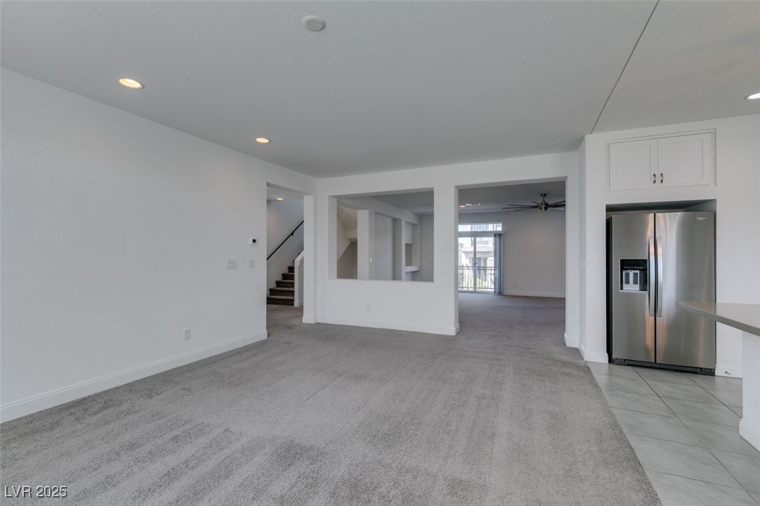 6335 Rock Strm Lane Las Vegas, NV 89141 - Photo 33 of 61 Unfurnished living room featuring recessed lighting, light colored carpet, stairway, ceiling fan, and light tile patterned flooring