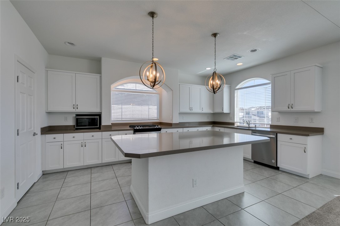 6335 Rock Strm Lane Las Vegas, NV 89141 - Photo 39 of 61 Kitchen featuring white cabinetry, pendant lighting, light tile patterned floors, appliances with stainless steel finishes, and recessed lighting