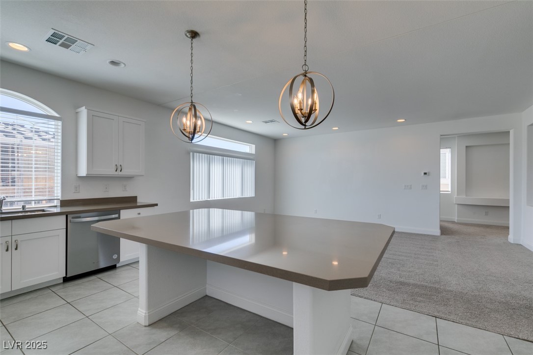 6335 Rock Strm Lane Las Vegas, NV 89141 - Photo 41 of 61 Kitchen with dark countertops, white cabinets, dishwasher, hanging light fixtures, and recessed lighting