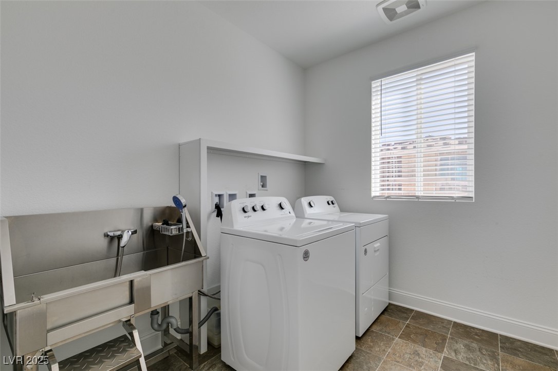 6335 Rock Strm Lane Las Vegas, NV 89141 - Photo 44 of 61 Laundry room featuring dark stone finish floors and washer and dryer