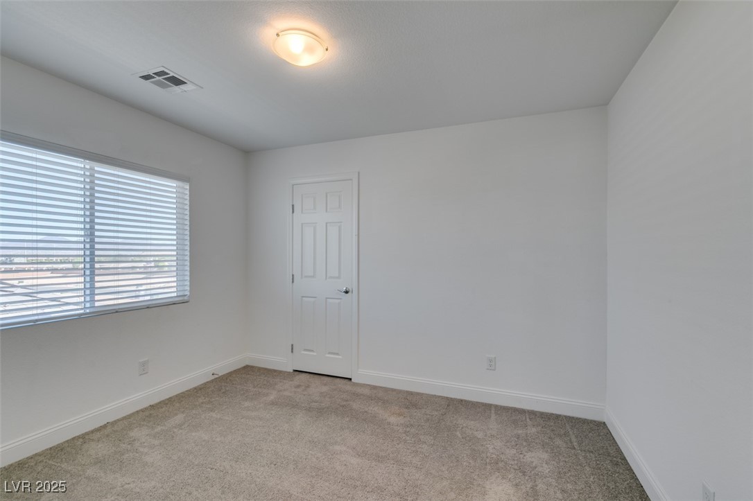 6335 Rock Strm Lane Las Vegas, NV 89141 - Photo 45 of 61 Spare room featuring light colored carpet and baseboards