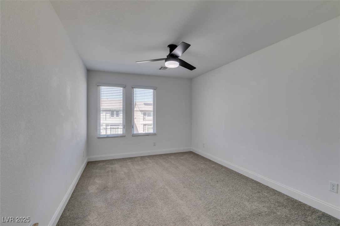 6335 Rock Strm Lane Las Vegas, NV 89141 - Photo 46 of 61 Empty room with light colored carpet and a ceiling fan