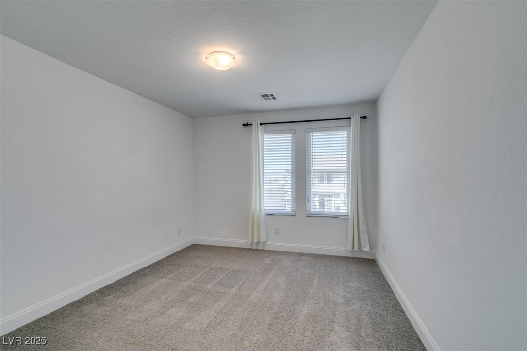 6335 Rock Strm Lane Las Vegas, NV 89141 - Photo 47 of 61 Empty room featuring light colored carpet and baseboards