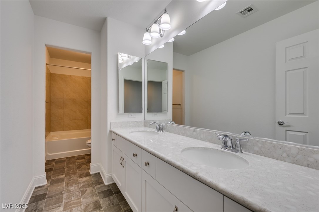 6335 Rock Strm Lane Las Vegas, NV 89141 - Photo 48 of 61 Bathroom with double vanity and shower combination
