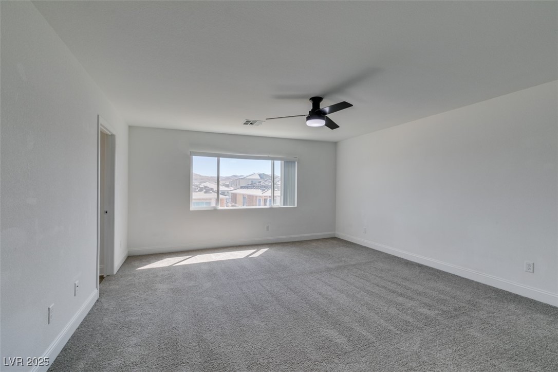 6335 Rock Strm Lane Las Vegas, NV 89141 - Photo 49 of 61 Carpeted spare room featuring baseboards and a ceiling fan