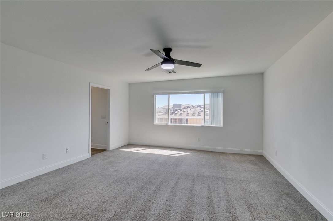 6335 Rock Strm Lane Las Vegas, NV 89141 - Photo 50 of 61 Carpeted empty room featuring a ceiling fan and baseboards