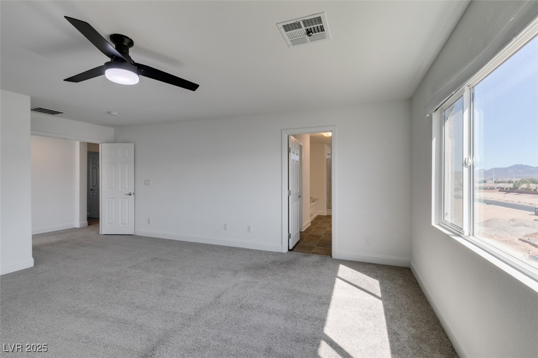 6335 Rock Strm Lane Las Vegas, NV 89141 - Photo 52 of 61 Unfurnished bedroom featuring light carpet, connected bathroom, and ceiling fan
