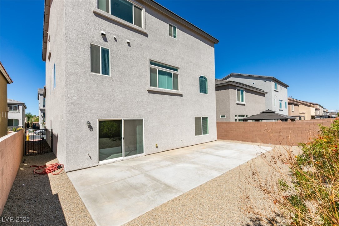 6335 Rock Strm Lane Las Vegas, NV 89141 - Photo 60 of 61 Rear view of property featuring a fenced backyard, a patio area, stucco siding, and a residential view