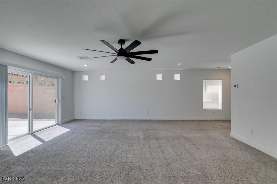 6335 Rock Strm Lane Las Vegas, NV 89141 - Photo 8 of 61 Unfurnished room featuring healthy amount of natural light, light colored carpet, ceiling fan, and recessed lighting