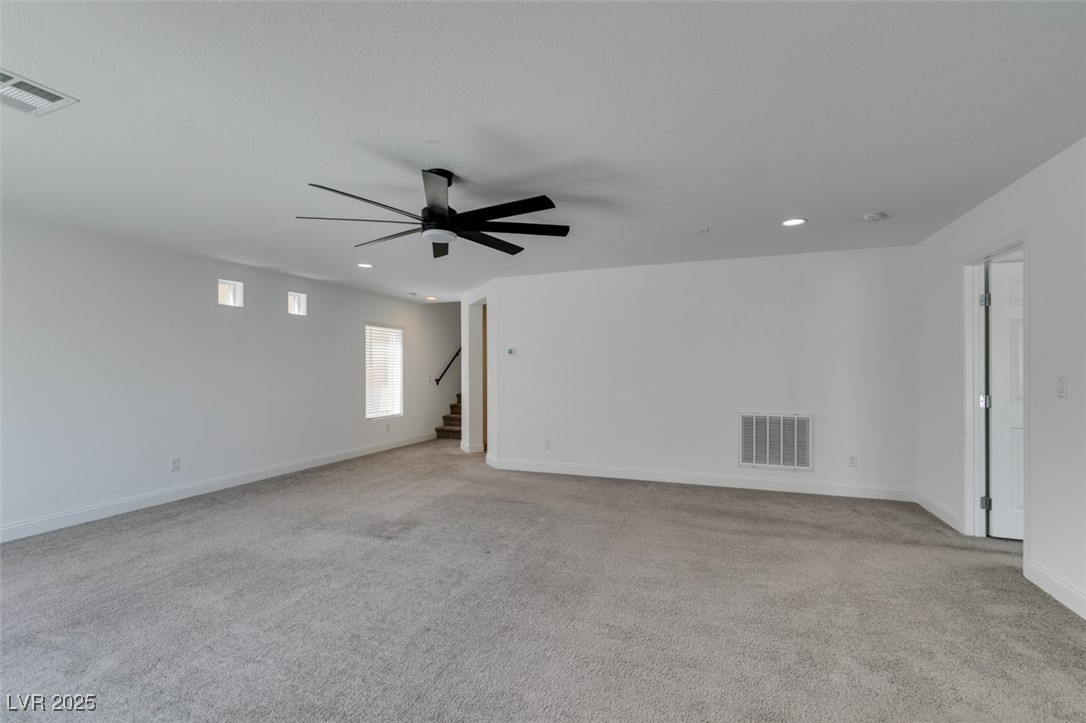 6335 Rock Strm Lane Las Vegas, NV 89141 - Photo 10 of 61 Empty room with light carpet, recessed lighting, stairway, and ceiling fan