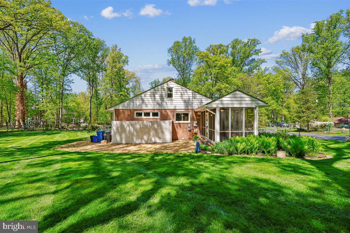 4318 Pinetree Road Rockville, MD 20853 - Photo 125 of 130 a front view of a house with a yard patio and green space