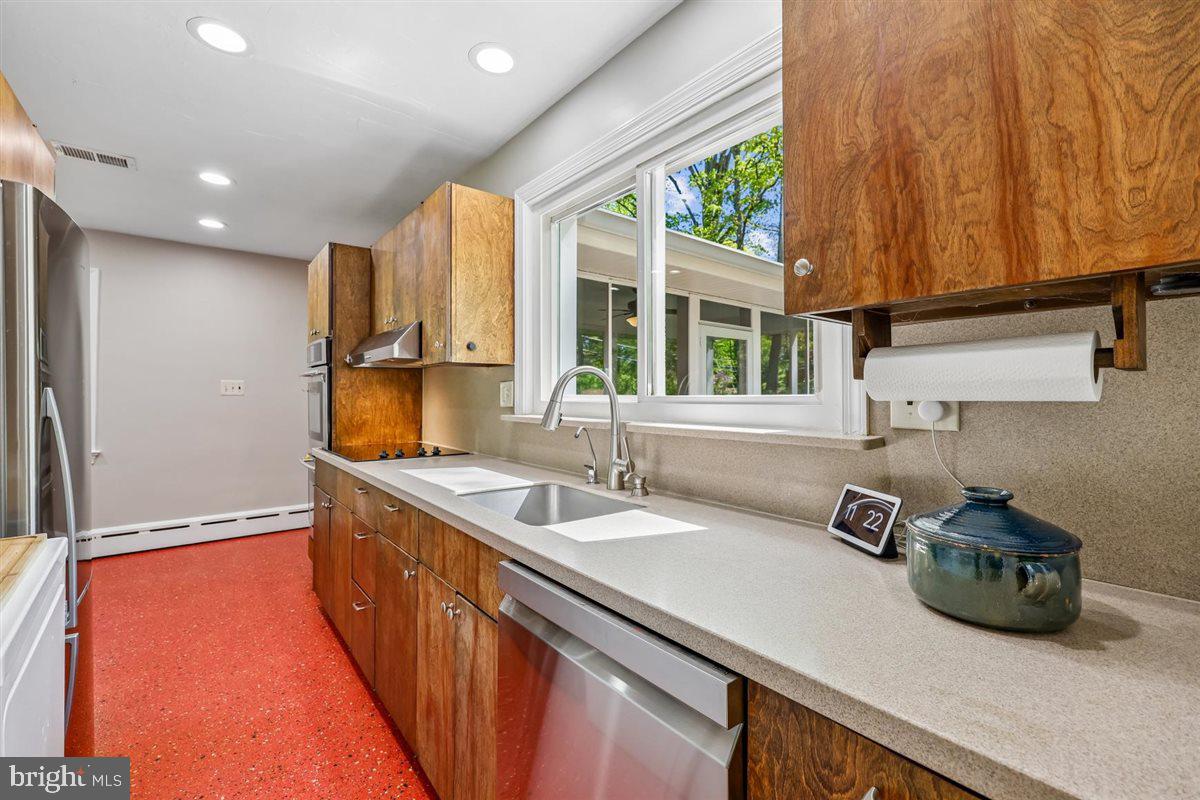4318 Pinetree Road Rockville, MD 20853 - Photo 50 of 130 a kitchen with stainless steel appliances a sink a counter space and a window