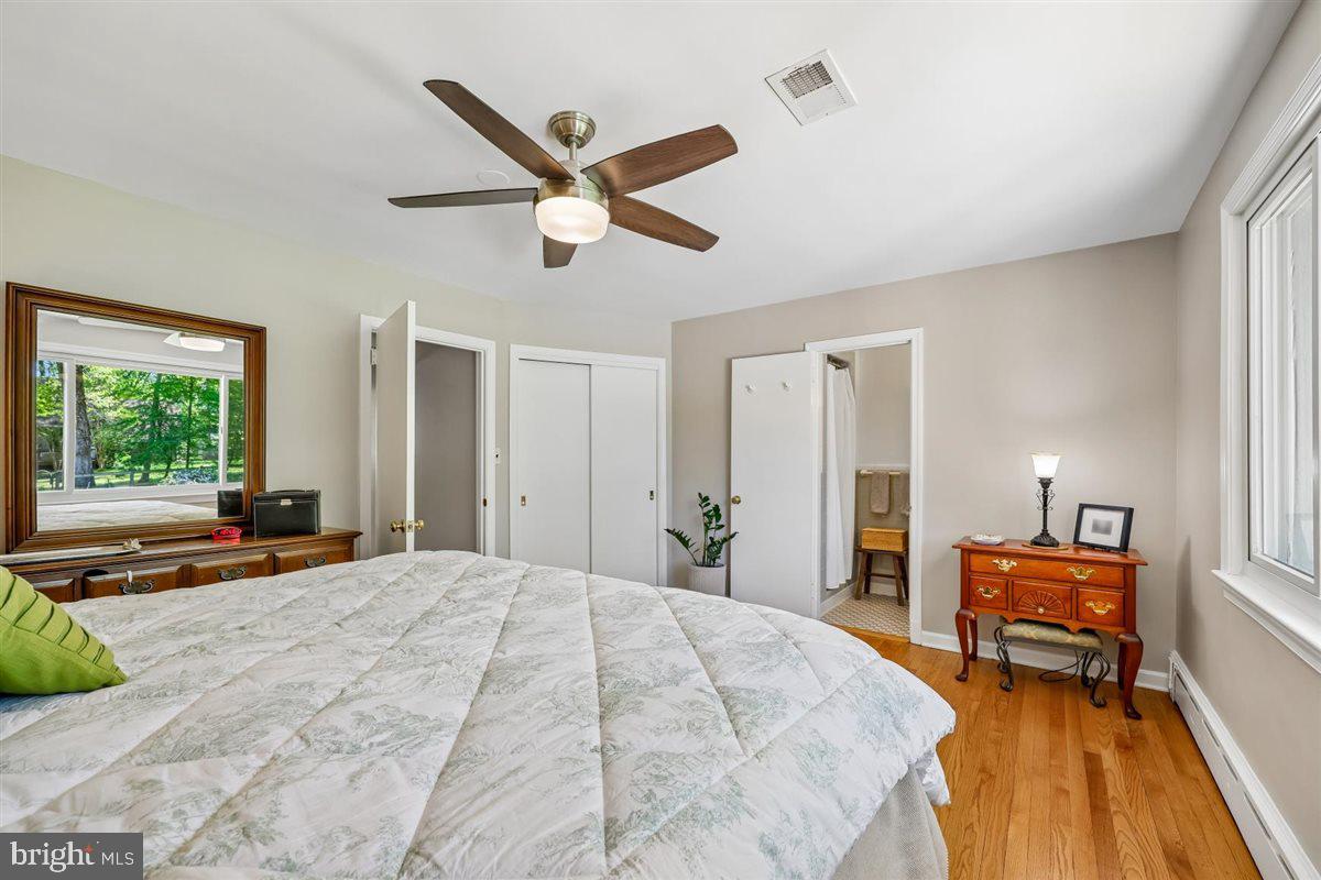 4318 Pinetree Road Rockville, MD 20853 - Photo 67 of 130 a bedroom with a bed a large window and a chandelier