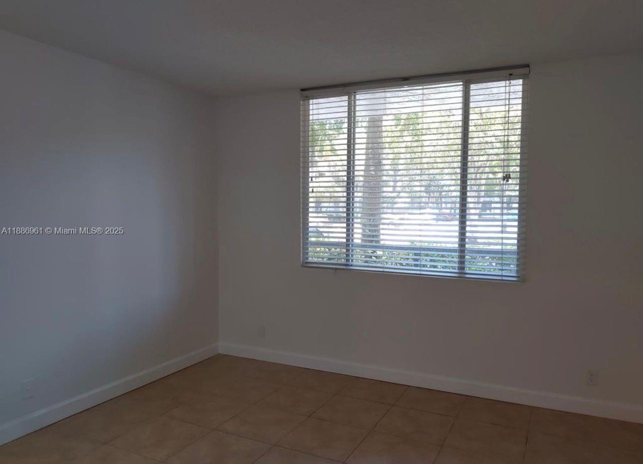 711 Lyons Road, Unit 14107 Coconut Creek, FL 33063 - Photo 12 of 24 an empty room with a window
