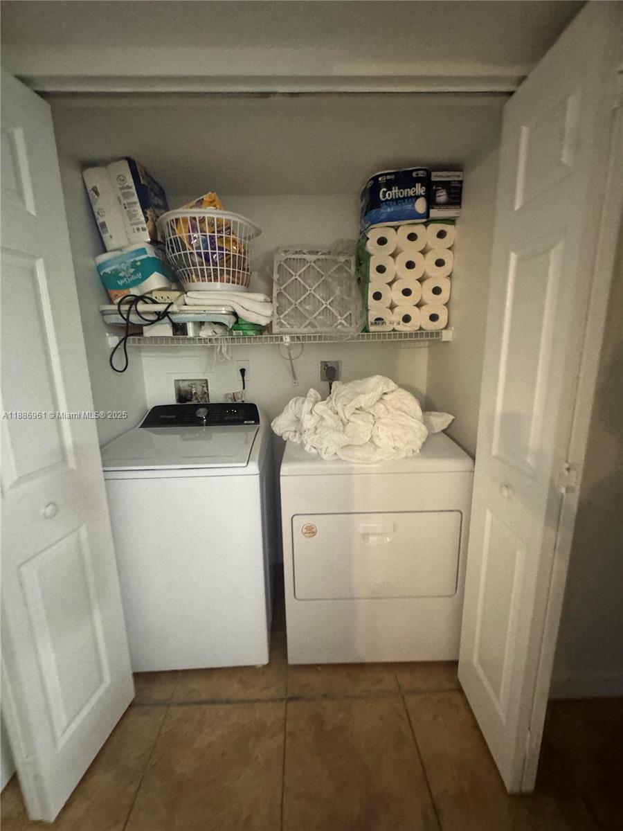 711 Lyons Road, Unit 14107 Coconut Creek, FL 33063 - Photo 14 of 24 a utility room with dryer and washer