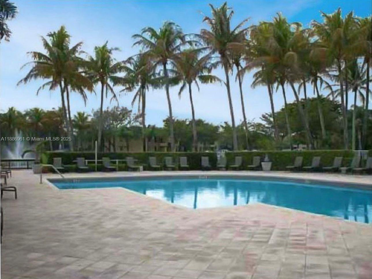 711 Lyons Road, Unit 14107 Coconut Creek, FL 33063 - Photo 19 of 24 a view of a swimming pool and a chair