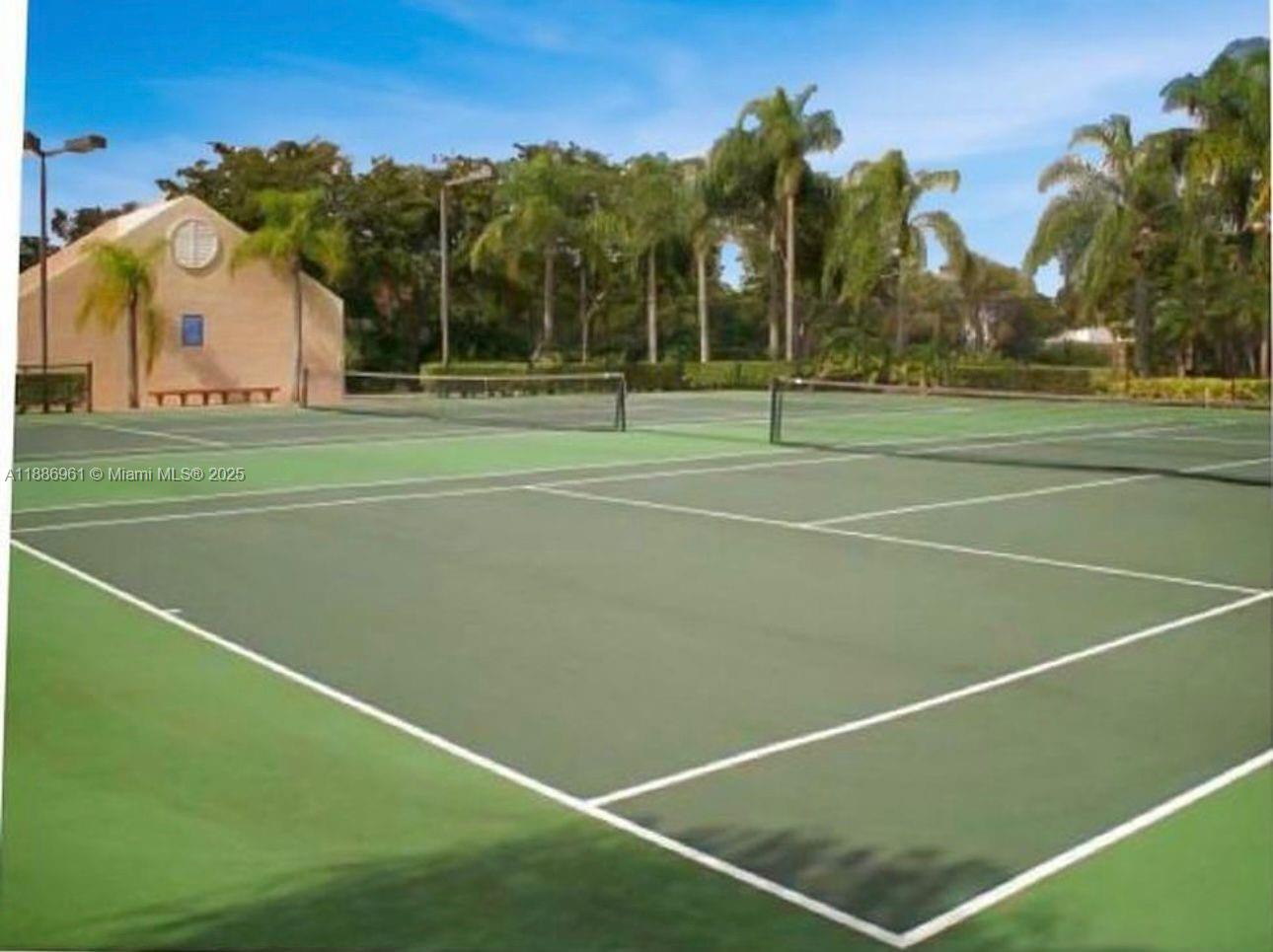 711 Lyons Road, Unit 14107 Coconut Creek, FL 33063 - Photo 20 of 24 a view of a tennis court