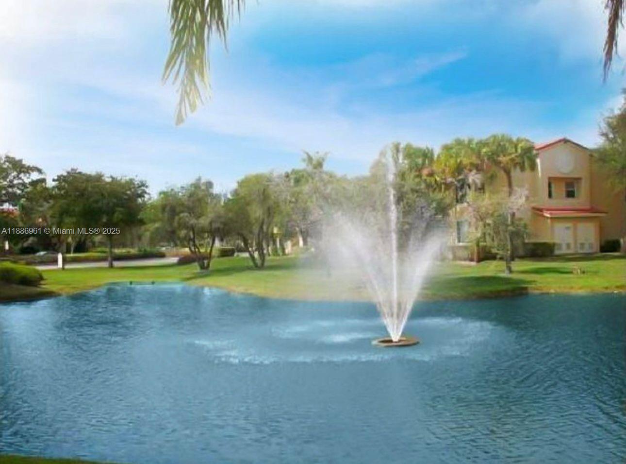 711 Lyons Road, Unit 14107 Coconut Creek, FL 33063 - Photo 22 of 24 a view of a house with a swimming pool